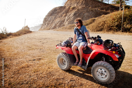 Photography Man in sunglasses sitting on quadbike