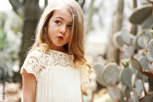 Girl puckering while looking away in backyard