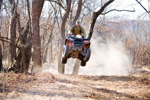 Man ridding quadbike on field