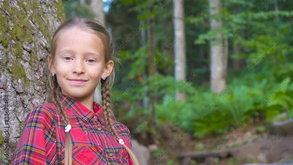 Beautiful happy little girl in mountains in the background of fog Beautiful happy little girl in mountains in the background of fog