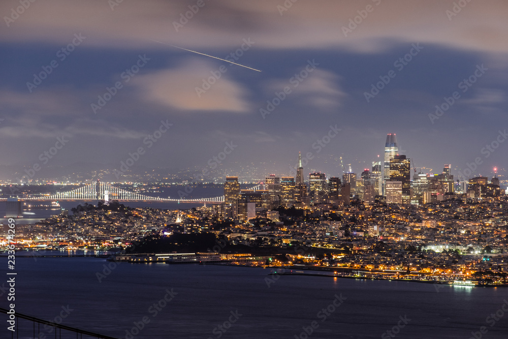 Night view of the Financial District and the lit up Bay Bridge, San Francisco, California