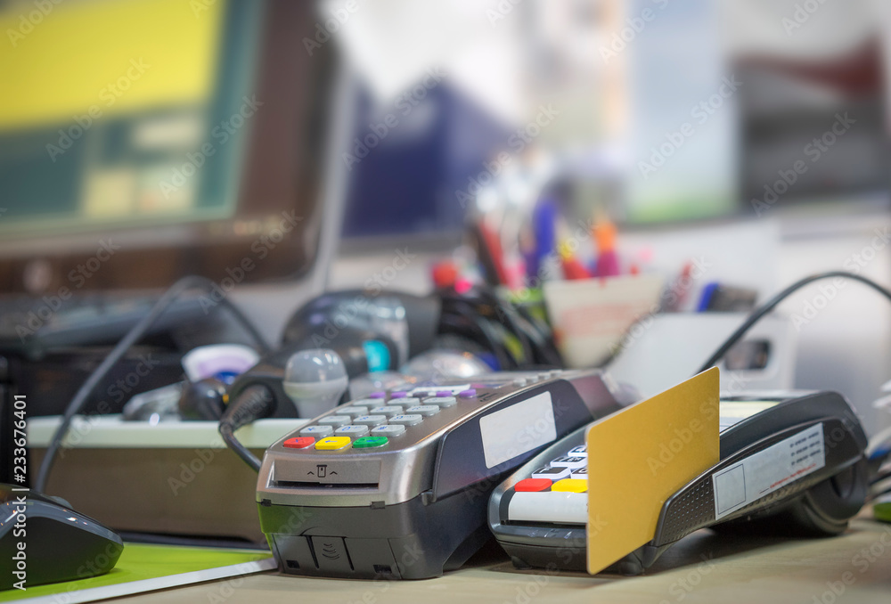 Credit Card reader on cashier table in supermarket Credit Card reader on cashier table in supermarket