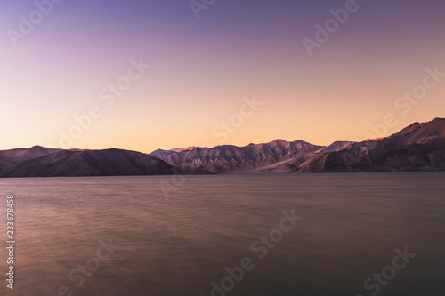 Sunset view with shades of the mountains on Pangong Tso, (Pangong lake) in Ladakh, India.