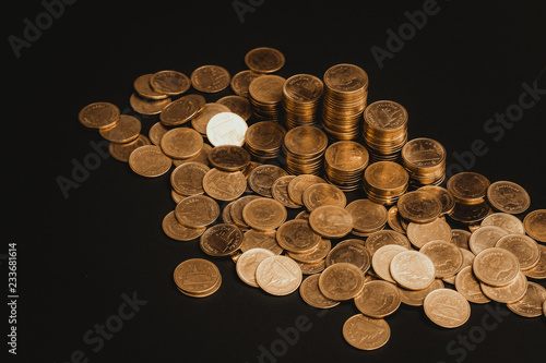 Savings  increasing columns of coins  piles of coins arranged as a graph in dark room  business banking concept.