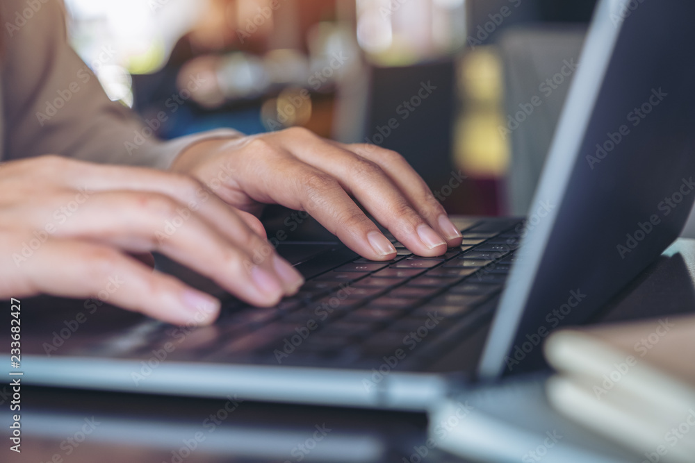 Closeup image of hands using and typing on laptop keyboard Closeup image of hands using and typing on laptop keyboard