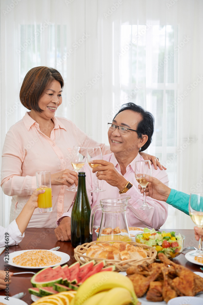 Hugging senior couple celebrating anniversary in family circle Hugging senior couple celebrating anniversary in family circle