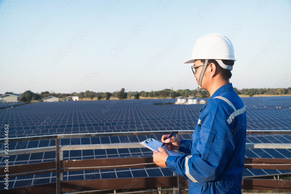 operation and maintenance in solar power plant ; engineering team working on checking and maintenance in solar power plant ,solar power plant to innovation of green energy for life