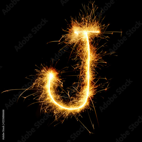 number and english alphabets from golden sparkler on black background