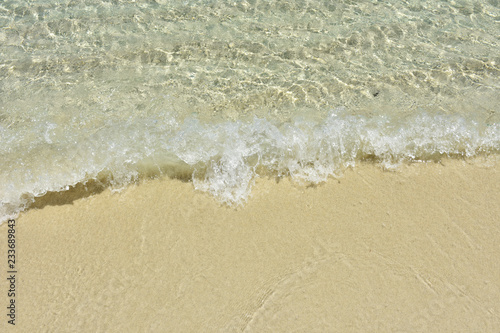 Clear sea water waves rushing to the soft fine sand beach. Close up of beach waves on of Lipe island,southern Thailand. © pondpony
