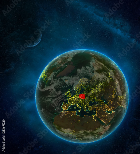 Poland from space on Earth at night surrounded by space with Moon and Milky Way. Detailed planet with city lights and clouds.