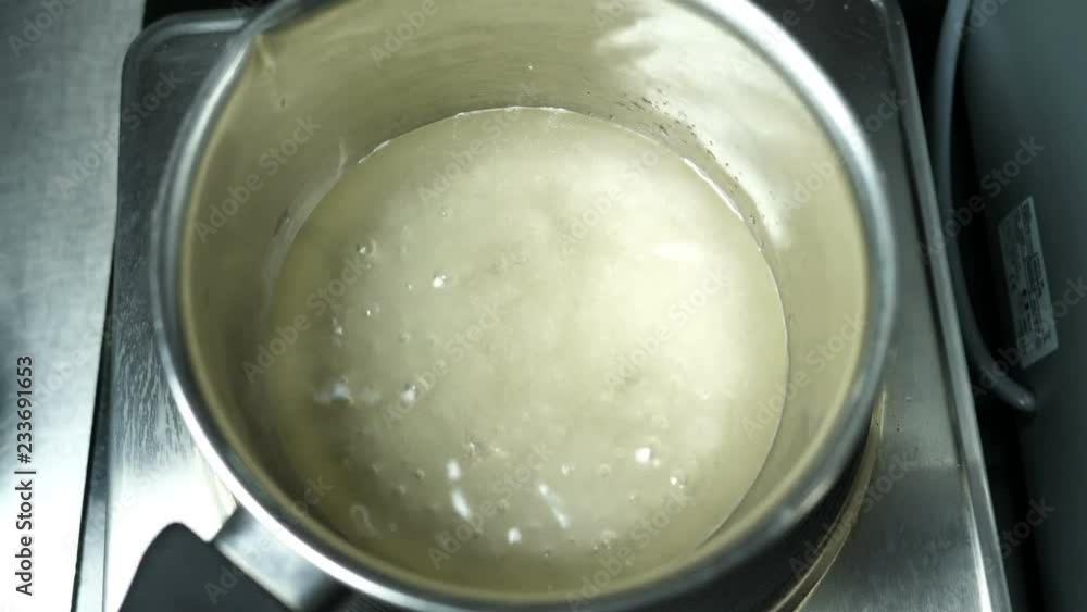 Boiling and bubbling sugar syrup and agar-agar in a saucepan on an electric cooker for making syrup, confectionery Boiling and bubbling sugar syrup and agar-agar in a saucepan on an electric cooker for making syrup, confectionery