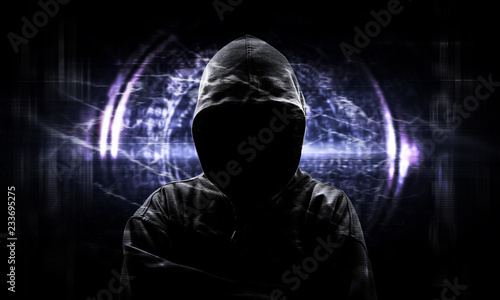 Silhouette of a hacker on black with binary codes
