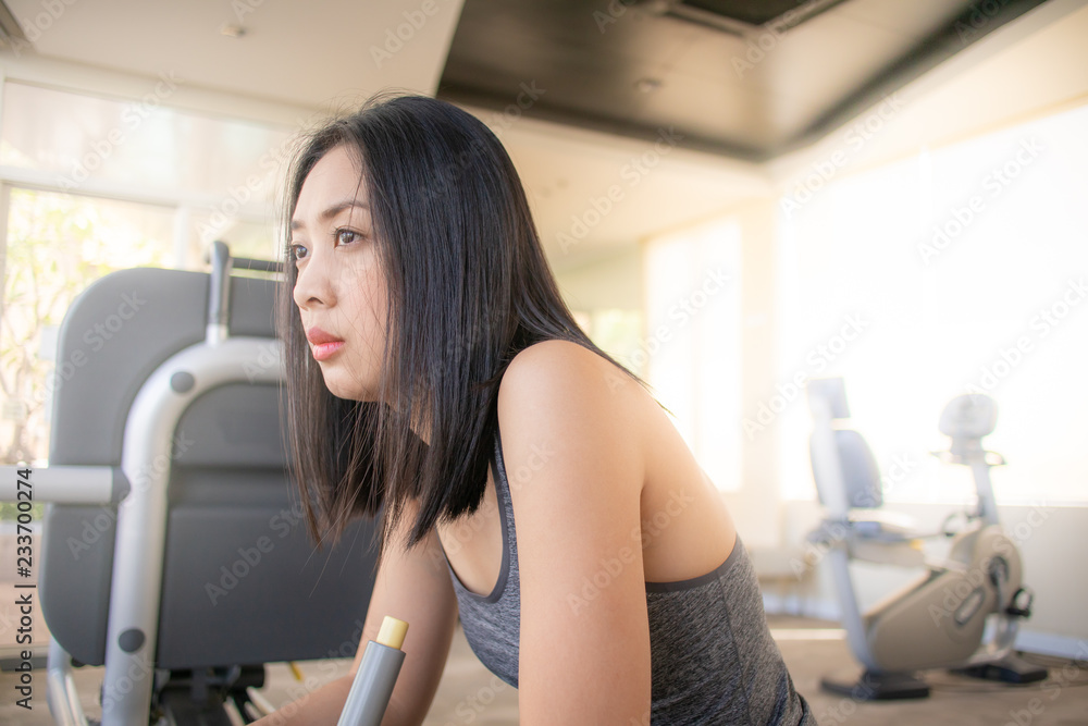 Woman resting from workout in the fitness gym.