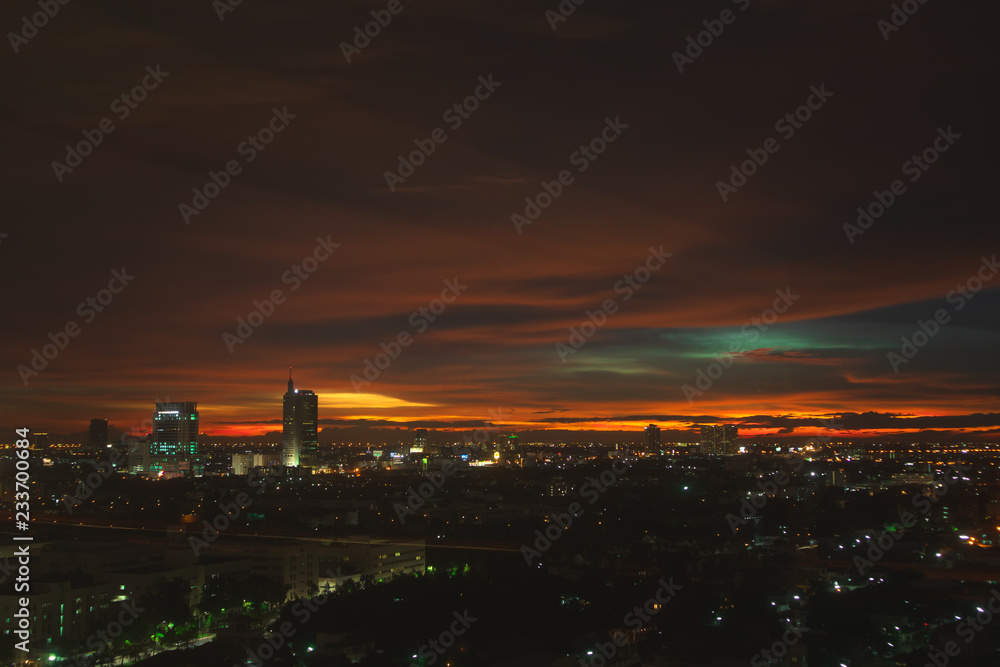 Twilight vivid orange sky over cityscape.