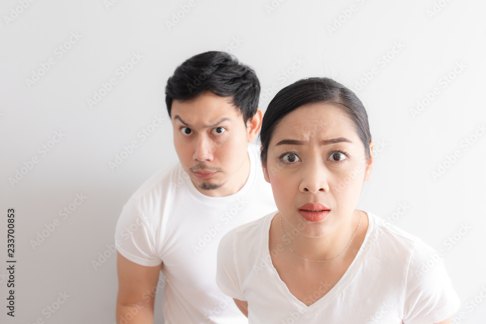 Funny face of lovers couple in doubt at an unbelievable thing that they are looking at Funny face of lovers couple in doubt at an unbelievable thing that they are looking at