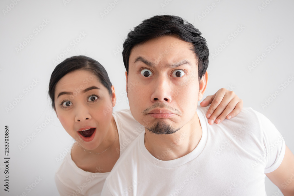 Funny face of lovers couple in doubt at an unbelievable thing that they are looking at Funny face of lovers couple in doubt at an unbelievable thing that they are looking at