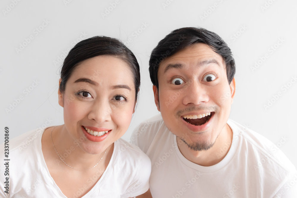 Surprised over couple funny face in white t-shirt and white background. Surprised over couple funny face in white t-shirt and white background.