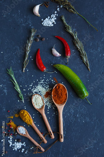 Herbs and spices on black background Food background. measuring spoon . spice spoon