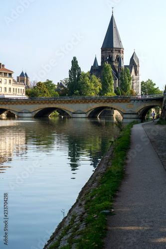 Ancient french castle near the bridge and river in the summer day under the blue sky in Metz © Anastasia Pestova