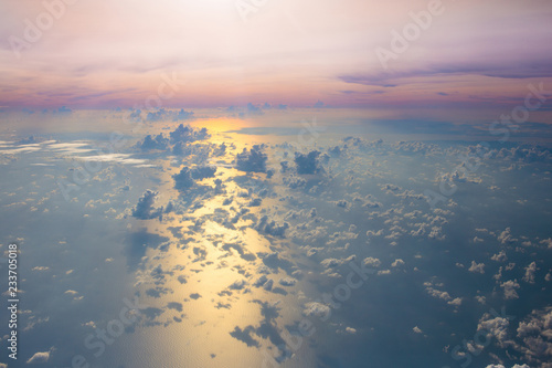 Ocean at sunset or sunrise, view from airplane