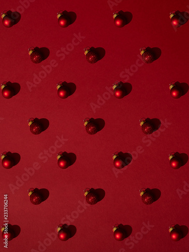 Christmas ornament with glass balls with hard shadows on red background
