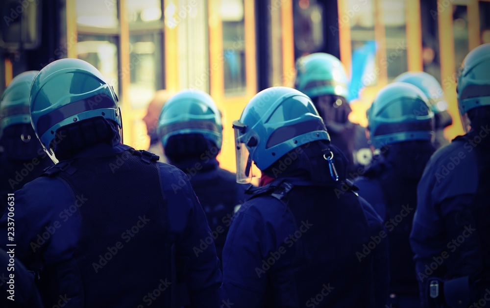 policemen in a riot gear during the uprising of the fans after a