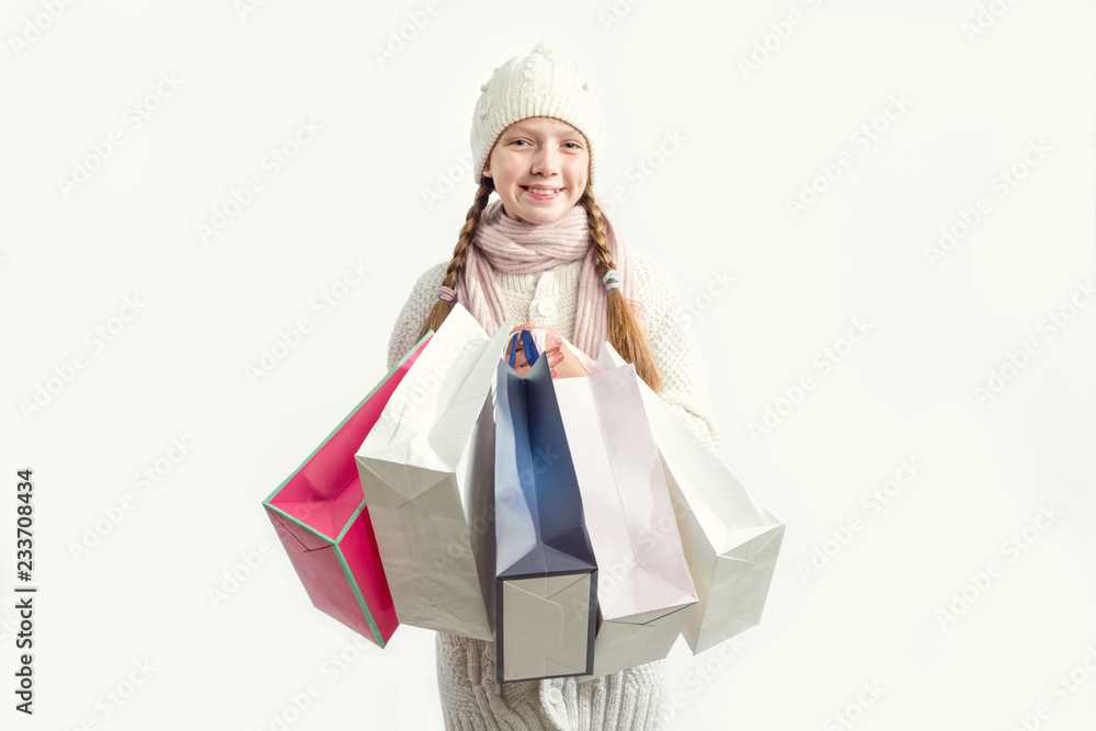 Girl with gift bags on a light background. Shopping before Christmas. Girl with gift bags on a light background. Shopping before Christmas.