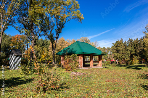Gazebo in the autumn park in sunny weather. The brightest time of autumn is golden autumn. Trees, before plunging into a long sleep, throw gold clothes from rapidly yellowing leaves. © Oleg