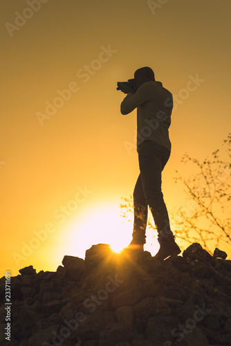 Black photographer at sunset