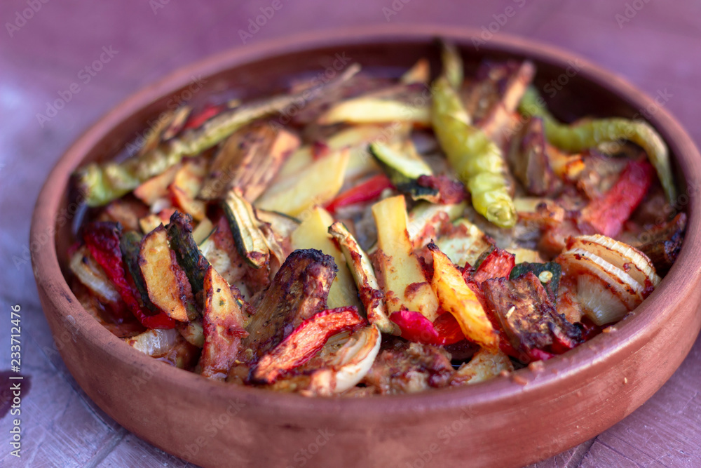 Angled positioned of onion, pepper, tomato meat meal in the traditional plate Angled positioned of onion, pepper, tomato meat meal in the traditional plate