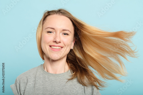woman with hair flying in the wind. haircare products and beauty concept.