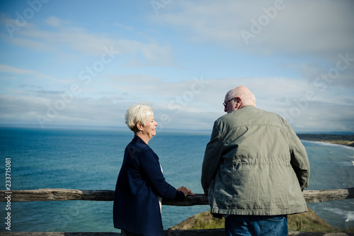 Happy senior couple enjoying the view of the ocean