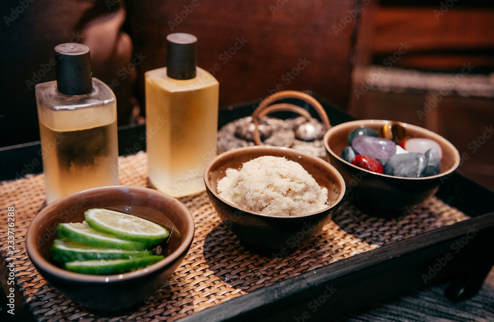 Asian Thai spa herbs ingredients and aroma massage oil on wood tray