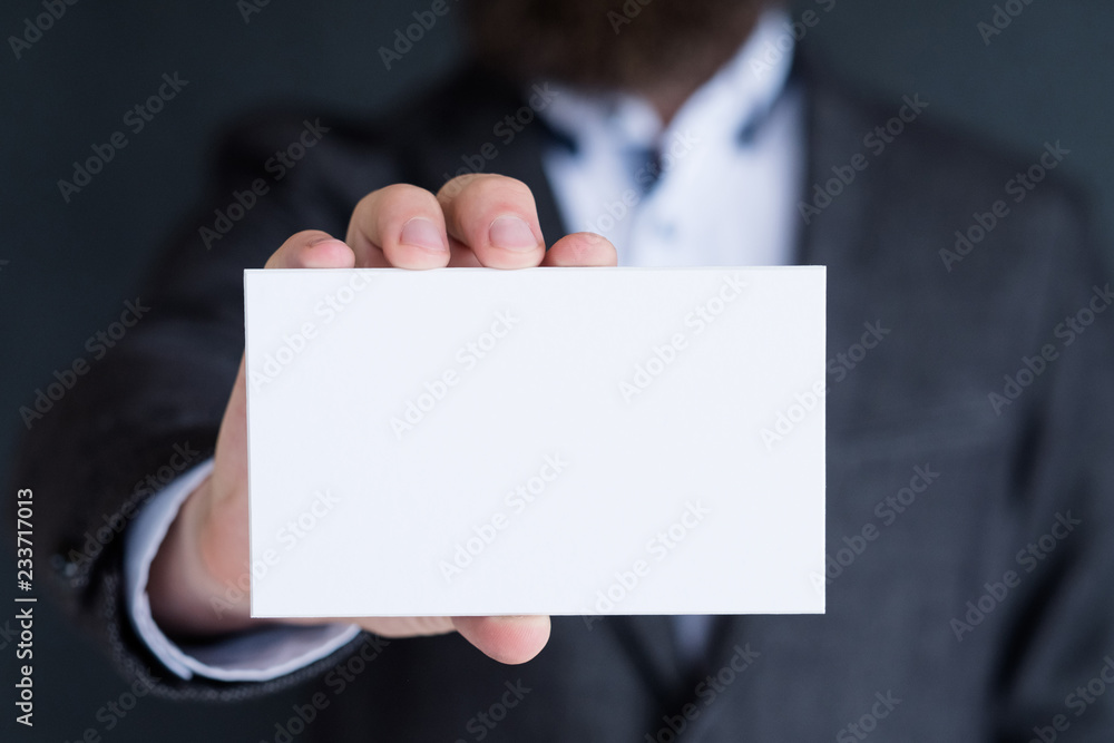 man holding blank white paper. information business card. empty space for advertisement. man holding blank white paper. information business card. empty space for advertisement.