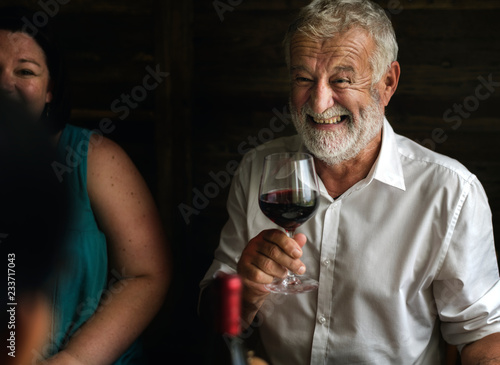 Cheerful man holding a wine glass photo