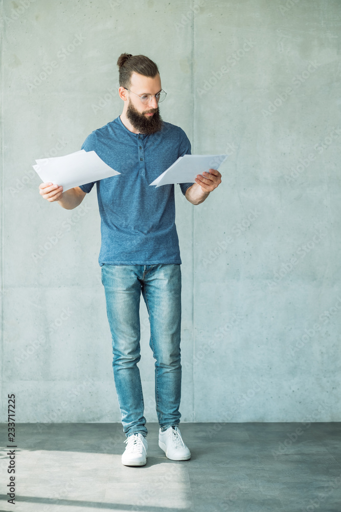 focused man reading or studying business documents. information analysis and paperwork focused man reading or studying business documents. information analysis and paperwork