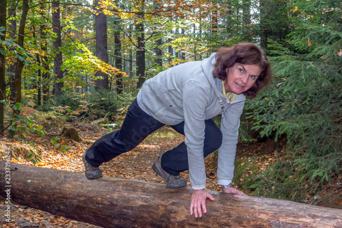 Woman is doing gymnastics in the forest photo