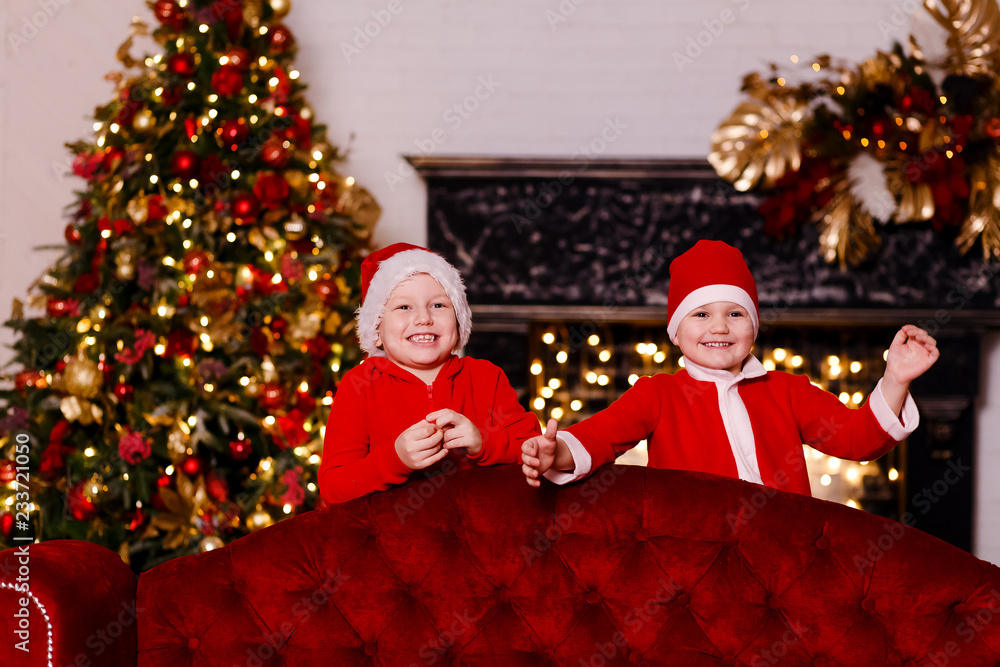 funny kids preschoolers in red clothes for the new year in the festive room funny kids preschoolers in red clothes for the new year in the festive room