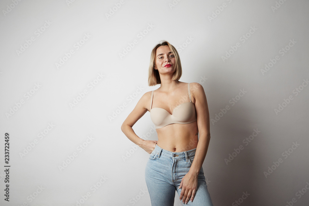 Beautiful woman wearing bra with blue jeans studio on white background.  Mock up. Stock Photo