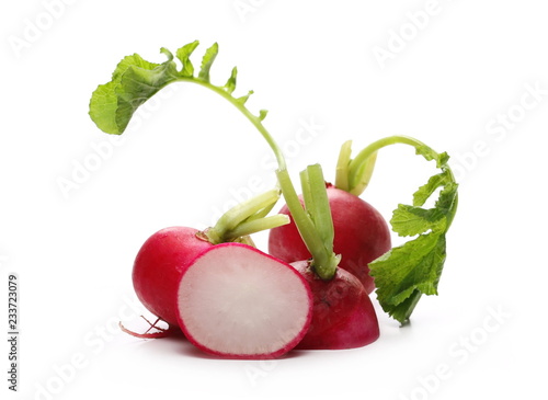 Fresh red radishes with leaves isolated on white background