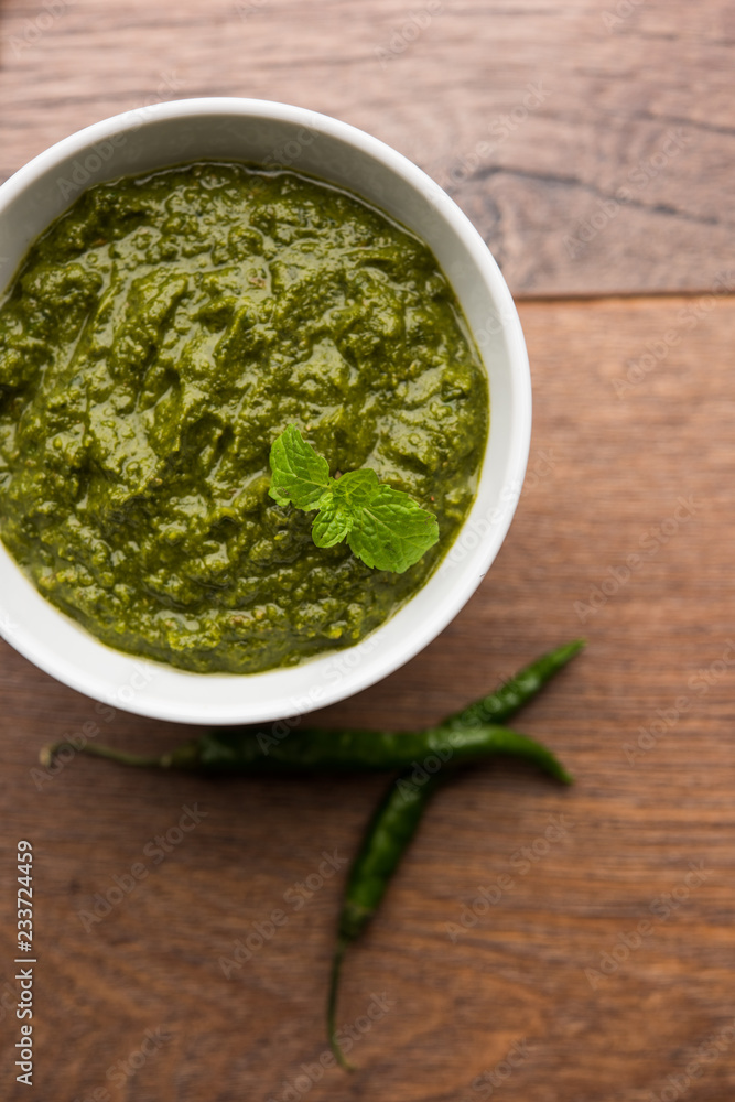 Healthy Indian Green Chutney or Sauce Made using Coriander, Mint And Spices. isolated over moody background. Selective focus Healthy Indian Green Chutney or Sauce Made using Coriander, Mint And Spices. isolated over moody background. Selective focus