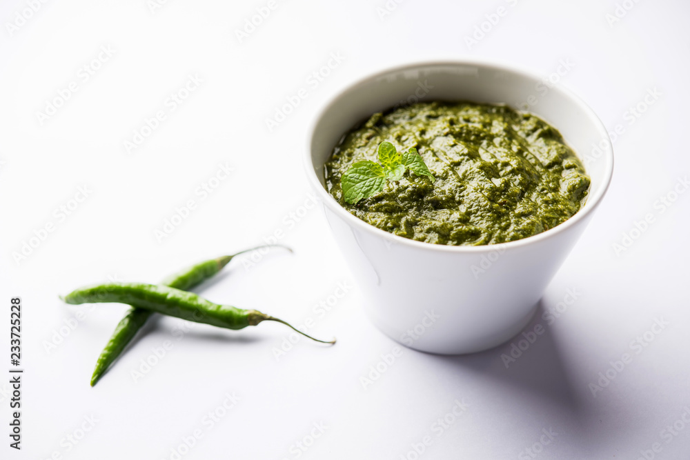 Healthy Indian Green Chutney or Sauce Made using Coriander, Mint And Spices. isolated over moody background. Selective focus
