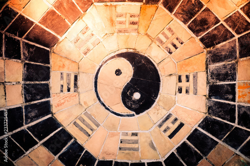 yin yang symbol on tiled wall.