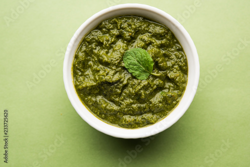 Healthy Indian Green Chutney or Sauce Made using Coriander, Mint And Spices. isolated over moody background. Selective focus