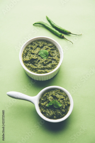 Healthy Indian Green Chutney or Sauce Made using Coriander, Mint And Spices. isolated over moody background. Selective focus