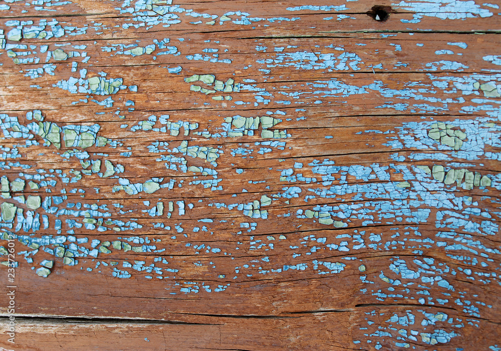Old wooden background with remains of pieces of scraps of old paint on wood. Texture of an old tree, board with paint, vintage background peeling paint. old blue board with cracked pain Old wooden background with remains of pieces of scraps of old paint on wood. Texture of an old tree, board with paint, vintage background peeling paint. old blue board with cracked pain