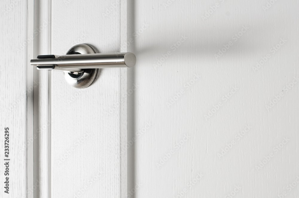 Closeup photo of metal door handle in modern style Closeup photo of metal door handle in modern style
