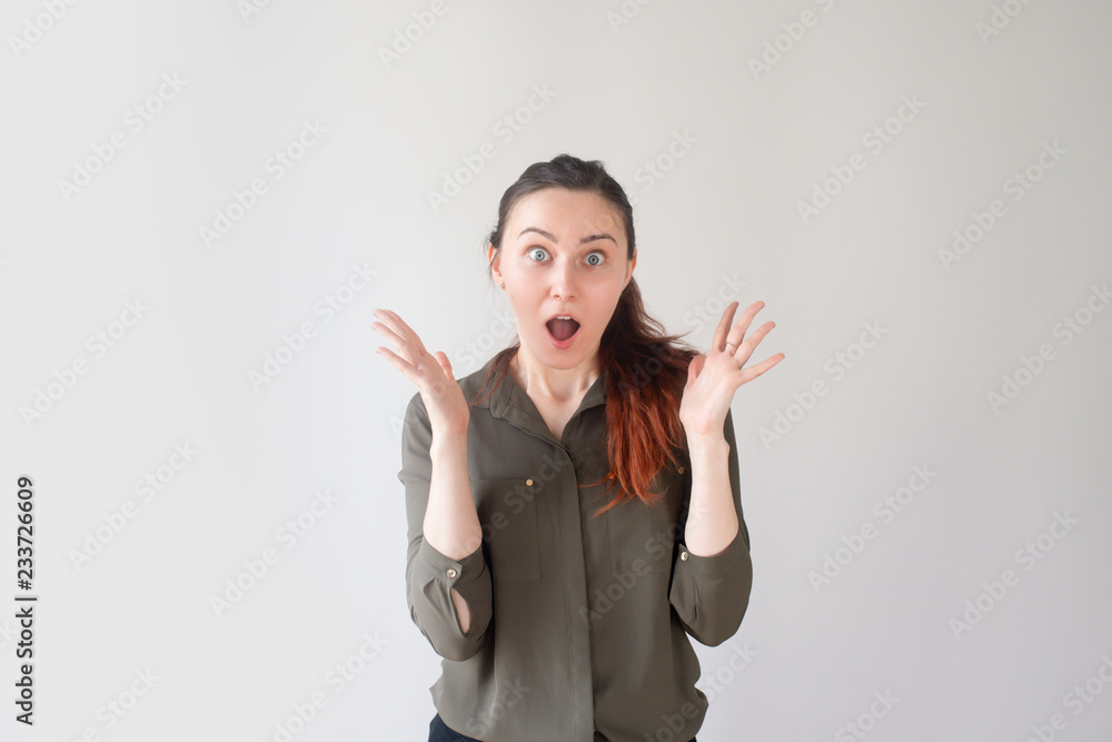 Shocked pretty Caucasian girl shouting with raised hands. Young female student displeased with announcement about exam. Sudden test concept Shocked pretty Caucasian girl shouting with raised hands. Young female student displeased with announcement about exam. Sudden test concept