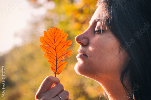 Girl with an autumn leaf  photo