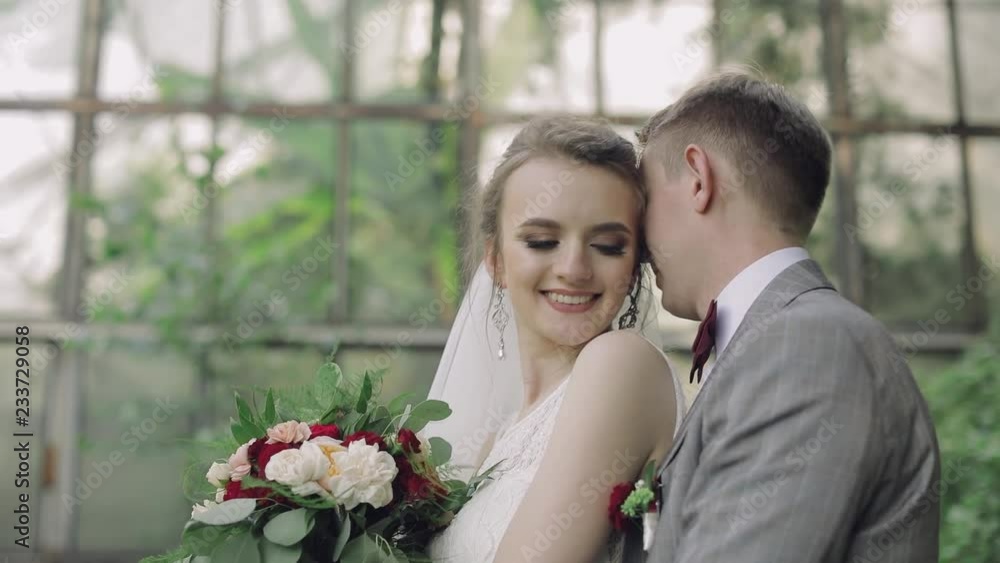 Young and beautiful wedding couple together in the park. Lovely groom and bride. Wedding day. Slow motion Young and beautiful wedding couple together in the park. Lovely groom and bride. Wedding day. Slow motion